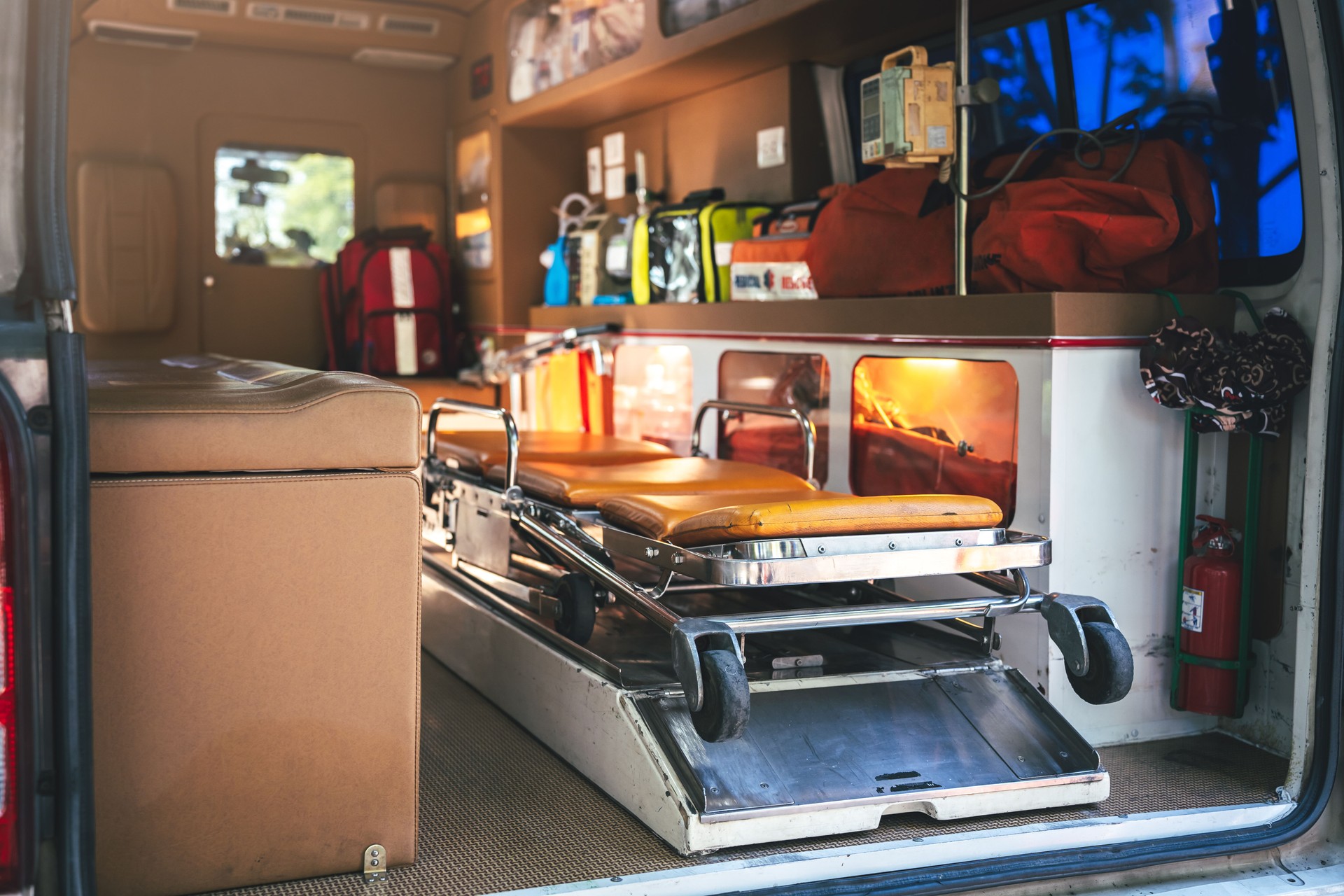 Emergency vehicle interior with patient stretcher and rescue equipment. Paramedics prepared for rapid response, ensuring safety and professional care during emergencies.